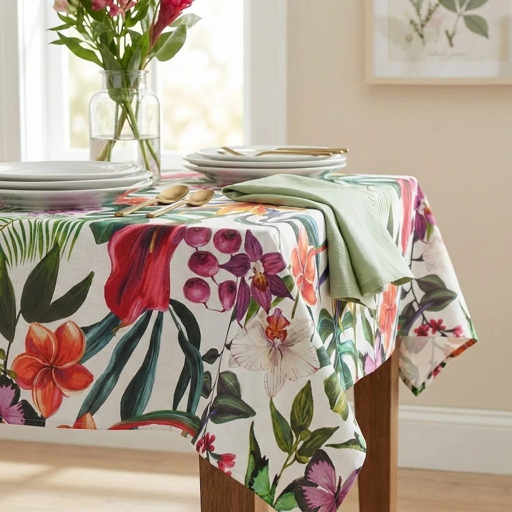 Lifestyle shot of Tropical Flowers Acrylic Coated Wipe Clean Tablecloth & hem Finish