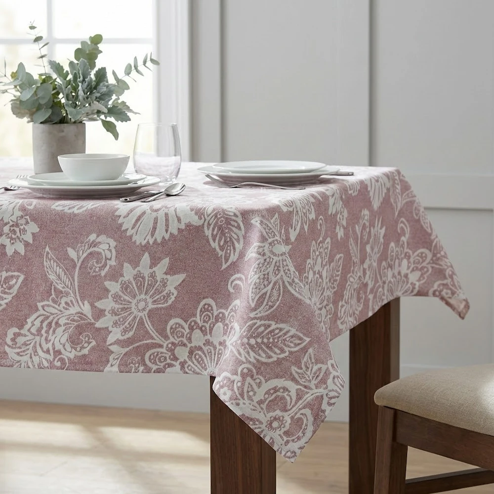 Lifestyle shot of Esta light bordeaux floral wipe clean tablecloth with hem finish